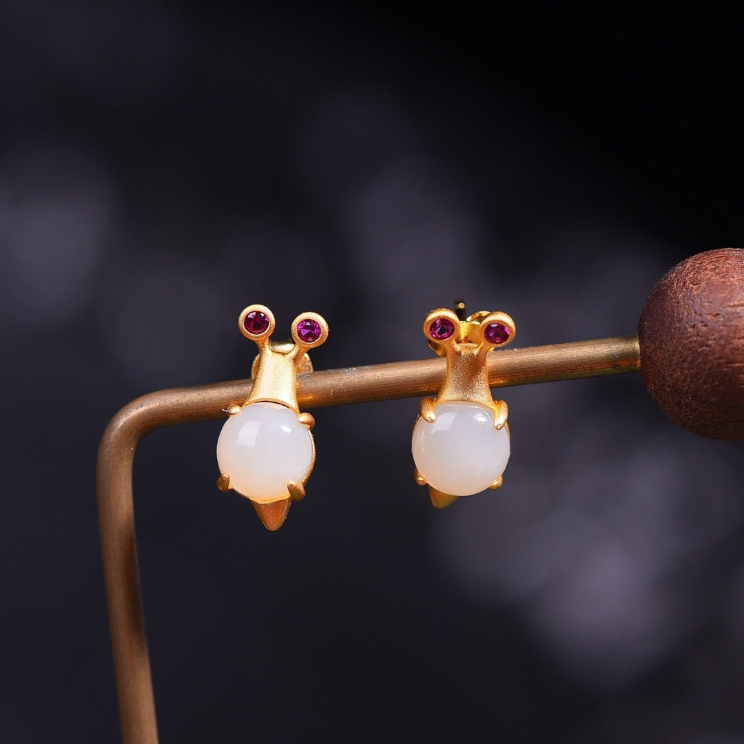 Charming handcrafted earrings shaped like mice, made of natural white jade and delicate rose gold details.