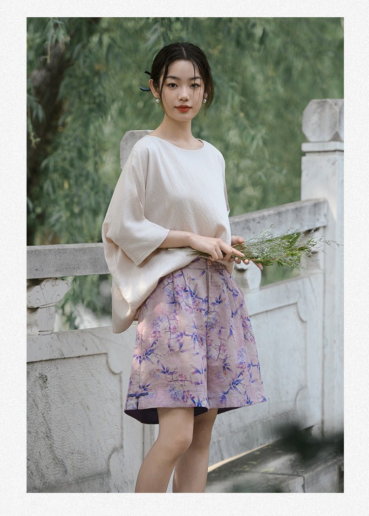Poised woman in loose linen set looking into the distance – natural and dreamy atmosphere