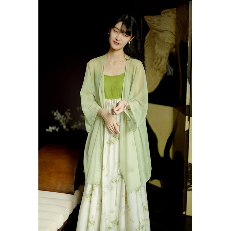 Poised in a pale green traditional Hanfu, she exudes quiet beauty and delicate charm.