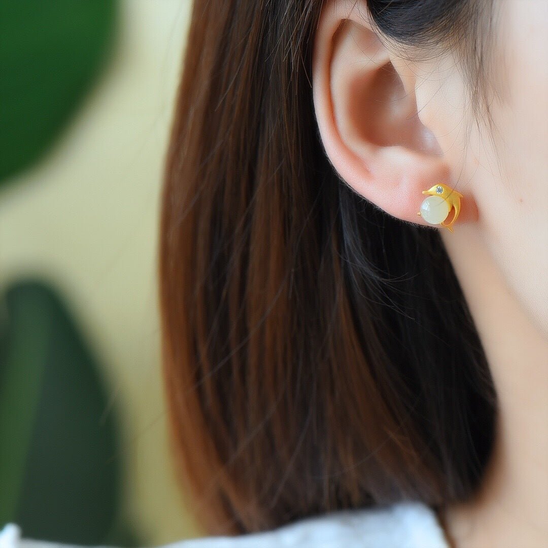 Minimalist white jade stud earrings with gold-plated frame — elegant and close to the skin.