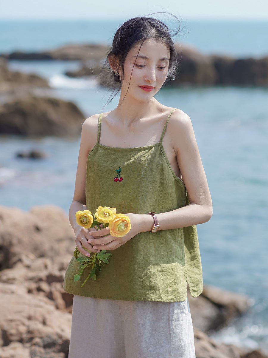 Woman standing by the sea in a soft-washed linen cami – gentle breeze, natural glow – Taichi Zen
