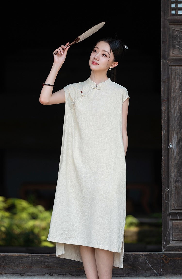 Elegant figure in a pale cream A-line dress, holding a hat in a peaceful nighttime setting.