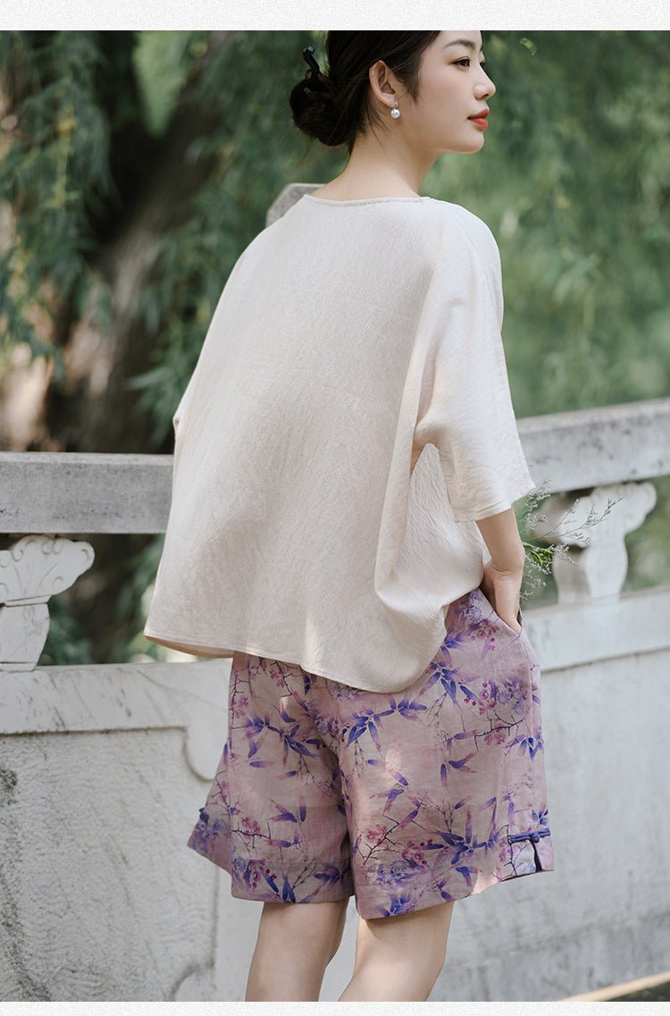 Back view of woman in relaxed outfit walking slowly – soft florals and quiet mood