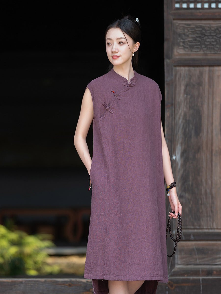 Model in a deep plum sleeveless dress with a relaxed silhouette, captured under soft lighting.