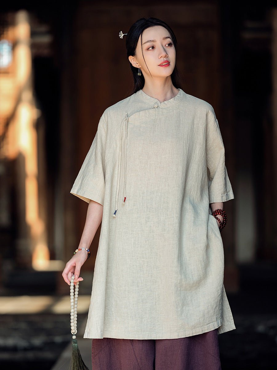 Model in taupe cotton-linen set with frog buttons, in soft indoor light and traditional courtyard setting