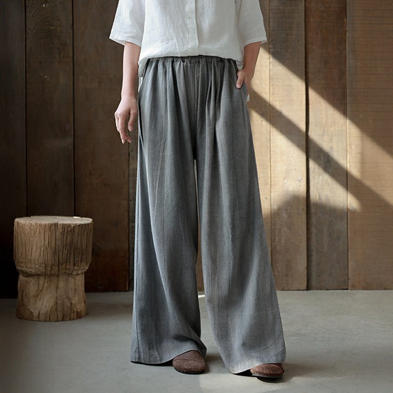Earth-toned drape pants in natural light – relaxed silhouette and gathered waistline, quietly composed