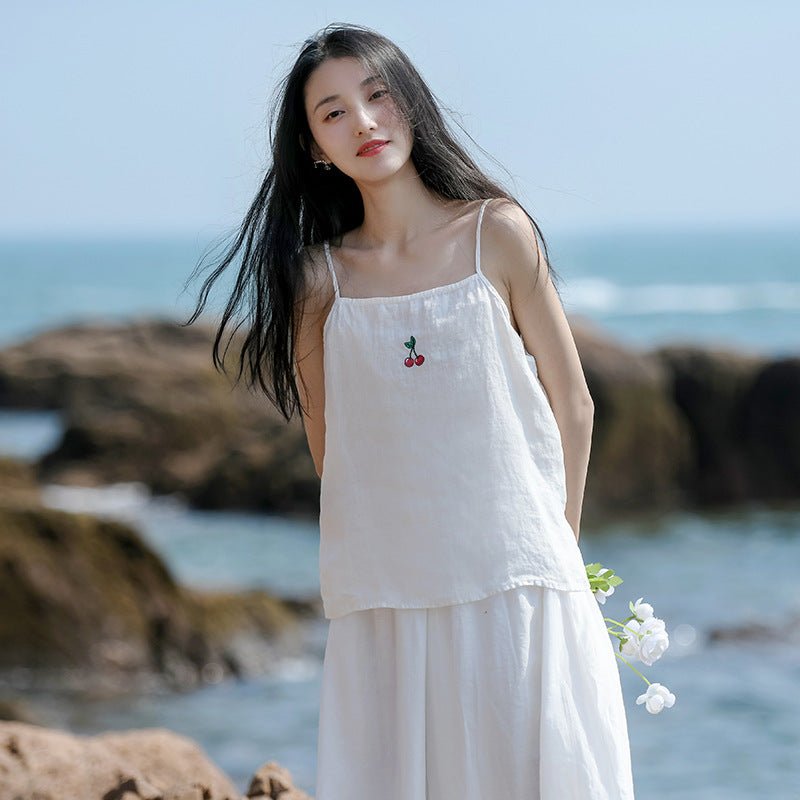Side view of the linen cherry cami worn over a flowing white skirt – serene, airy summer feeling